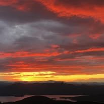 Gorgeous sunset in the Adirondacks overlooking the Mountains and body of water.